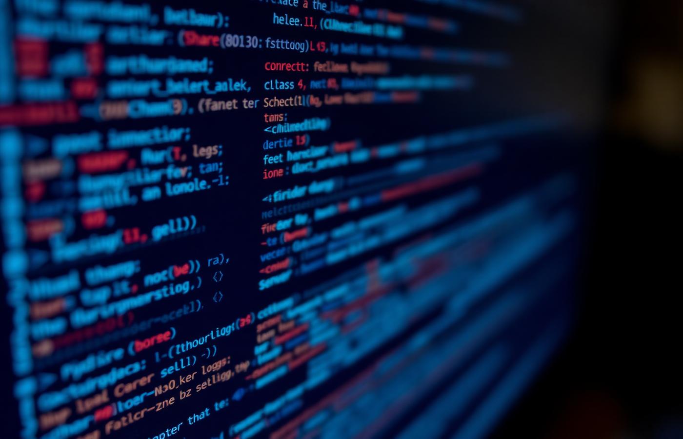 Close macro view of source code on a dark monitor